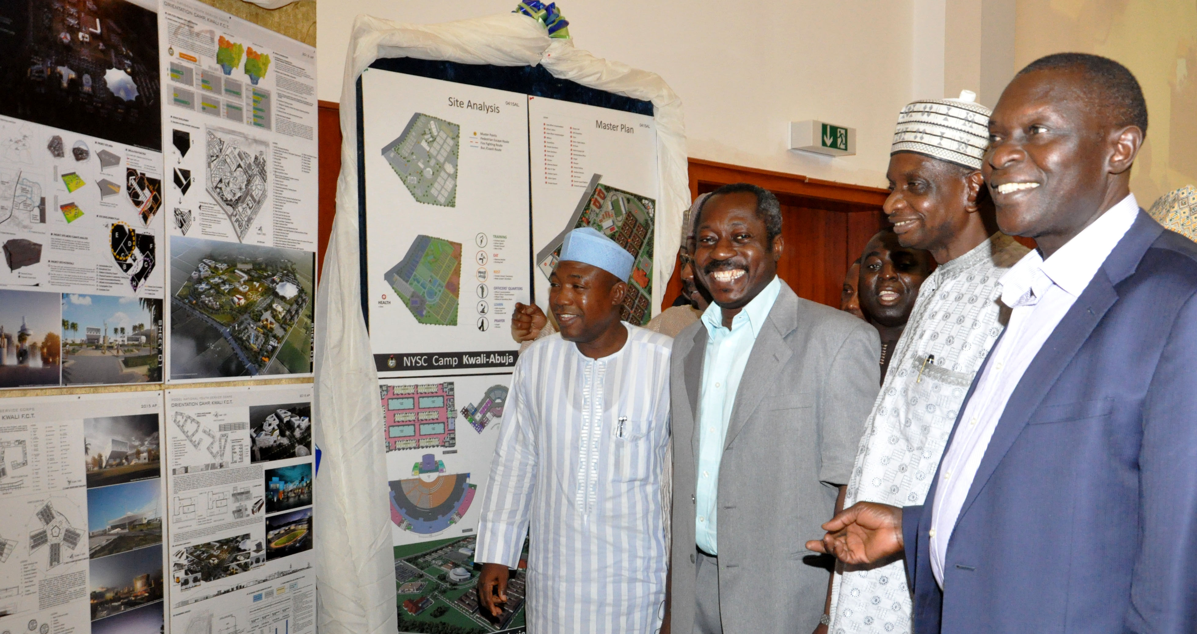 PIC. 9. FROM LEFT: DIRECTOR OF PROCUREMENT, FCDA, ALHAJI ADEWALE DAMBTA; DEPUTY DIRECTOR, ARCHITECTURE, PUBLIC BUILDING DEPARTMENT, MR ADEBOWALE ADEMO; DIRECTOR, SATELLITE TOWN DEVELOPMENT, MR SOSO MOHAMMED AND DIRECTOR, PUBLIC BUILDING, MR BERNARD LOT, ADMIRING THE MASTER PLAN CONCEPT OF THE WINNING ENTRY OF THE ARCHITECTURAL DESIGN COMPETITION FOR THE MODEL NYSC ORIENTATION CAMP, KWALI IN ABUJA ON WEDNESDAY (8/4/15). 1850/8/4/2015/OTU/CH/BJO/NAN