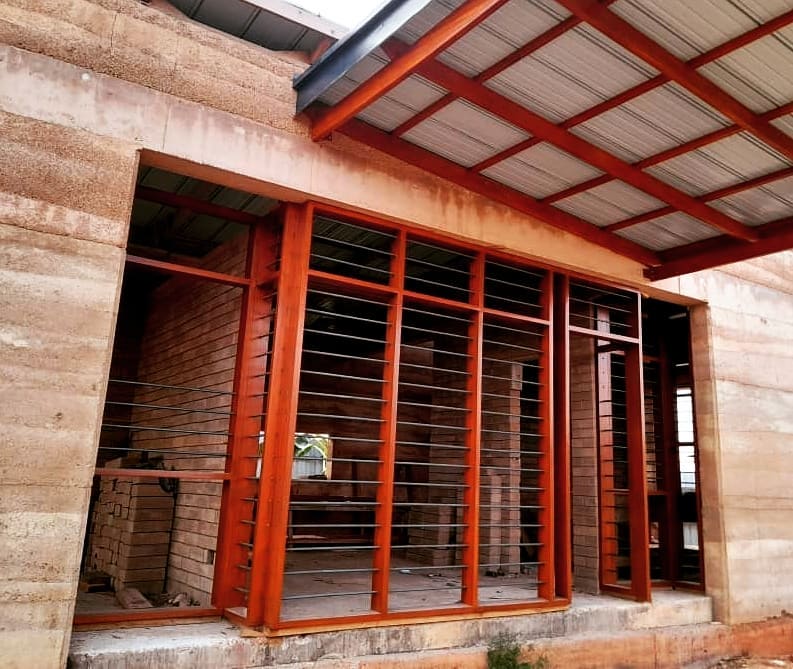 Wood Window Frames in carport of Pata 4 Two Housing Unit by OOA