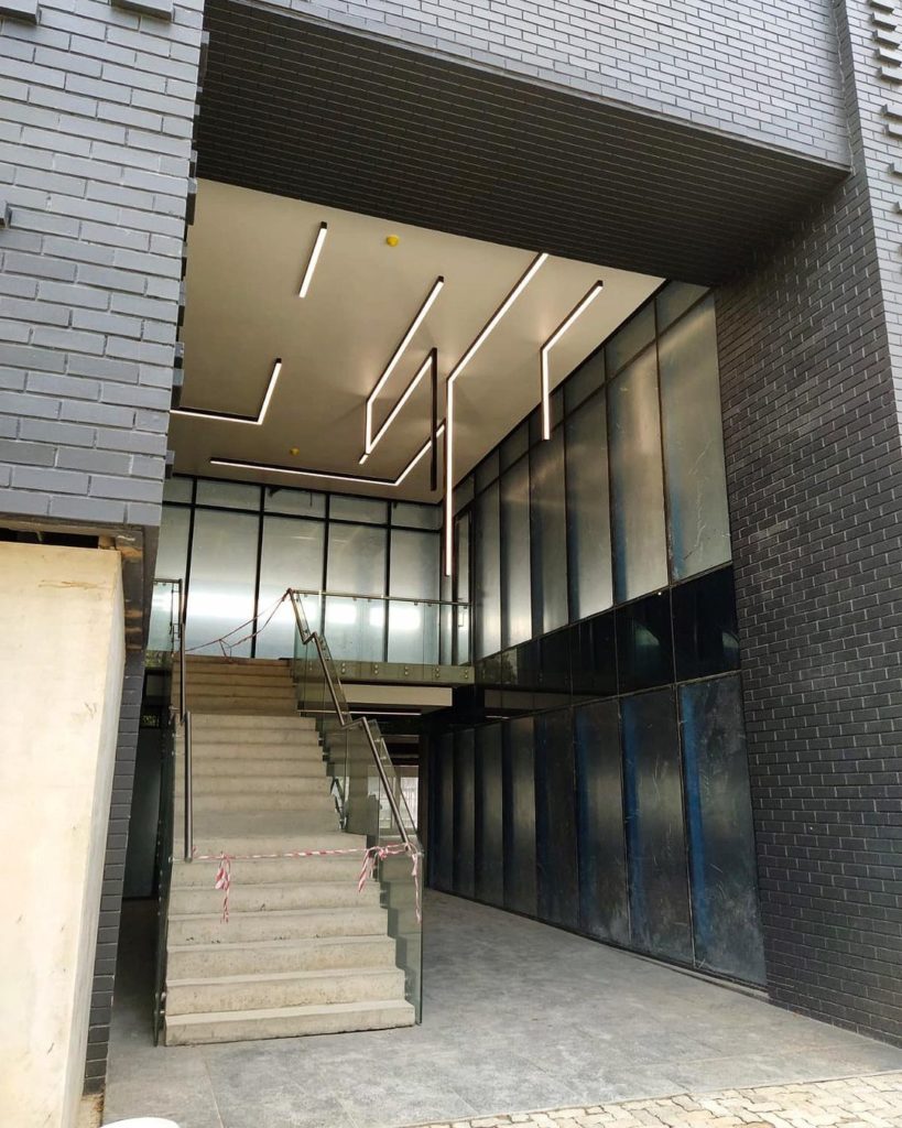 main entrance of 31 commerce showing modern linear ceiling lights