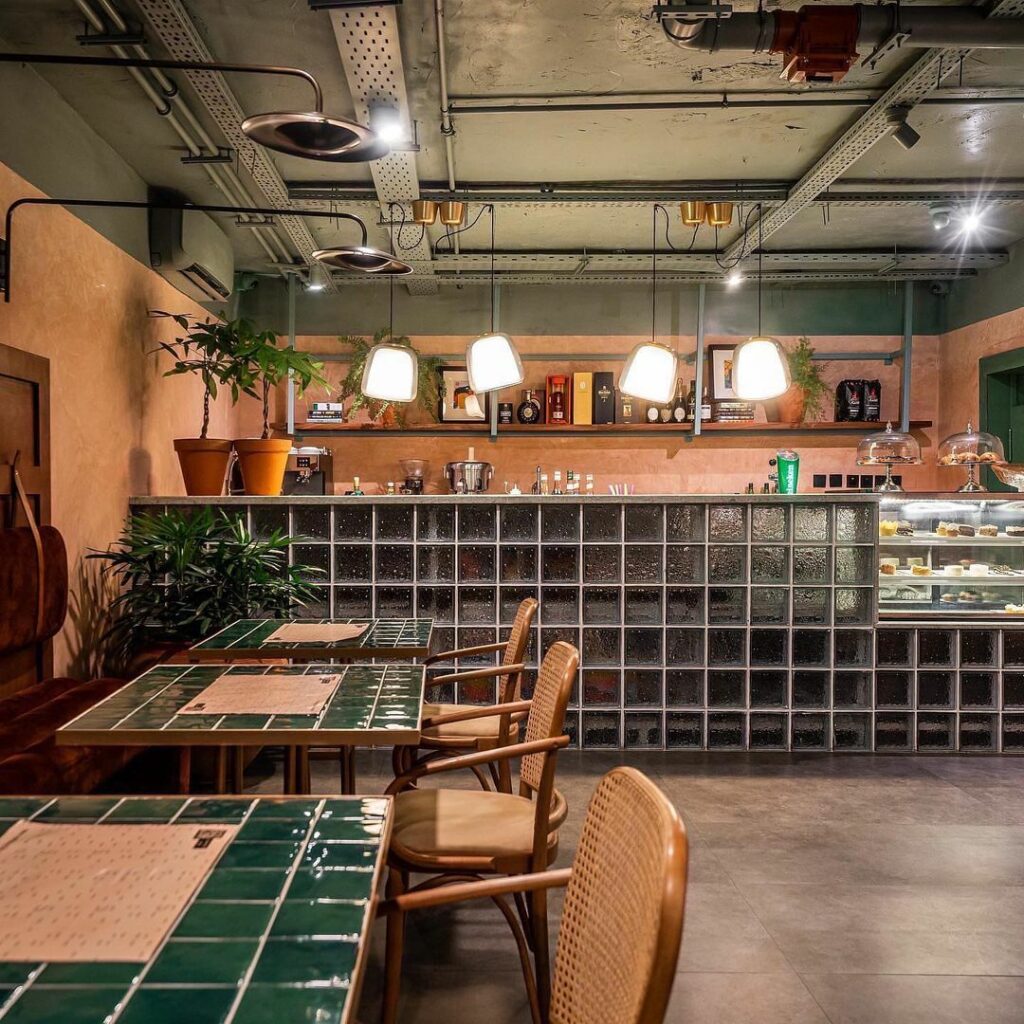 A view showing the exposed ceiling and glass block counter of the Eclectic Retro-Industrial Restaurant by S.EA Consulting