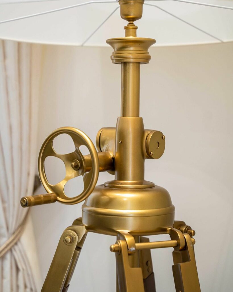 Brass floor lamp in Double-volume living room design by ISD Studio