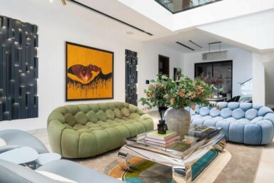 View of seating layout in Double-volume living room design by ISD Studio