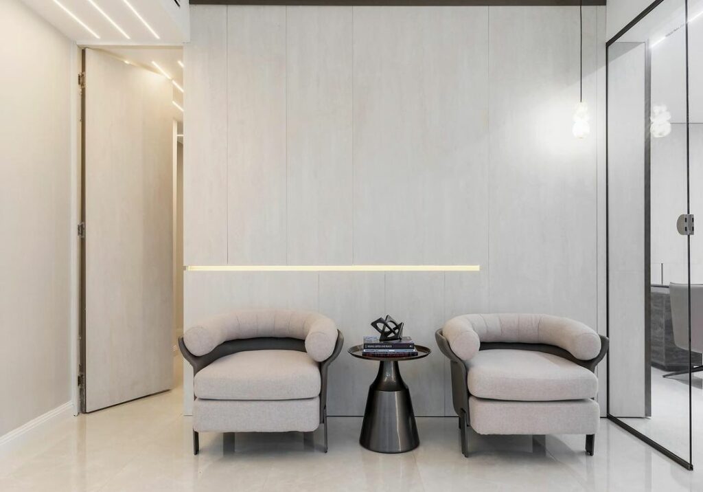 Waiting area in minimalist executive office design by Minida Designs