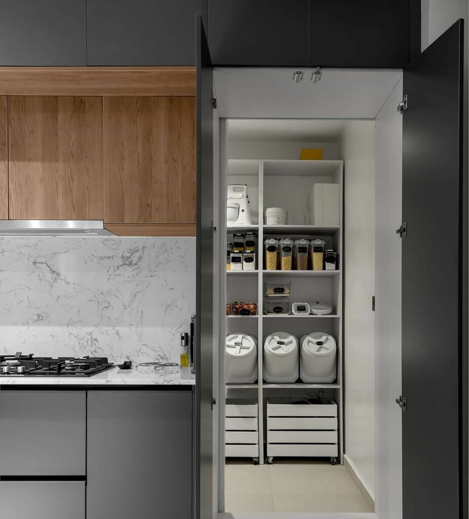 Hidden pantry in Modern grey Kitchen Layout by Kitdrobe