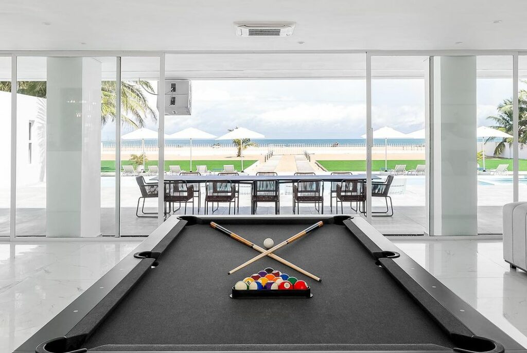 Pool table in Salt beach house by Studio Kumolu