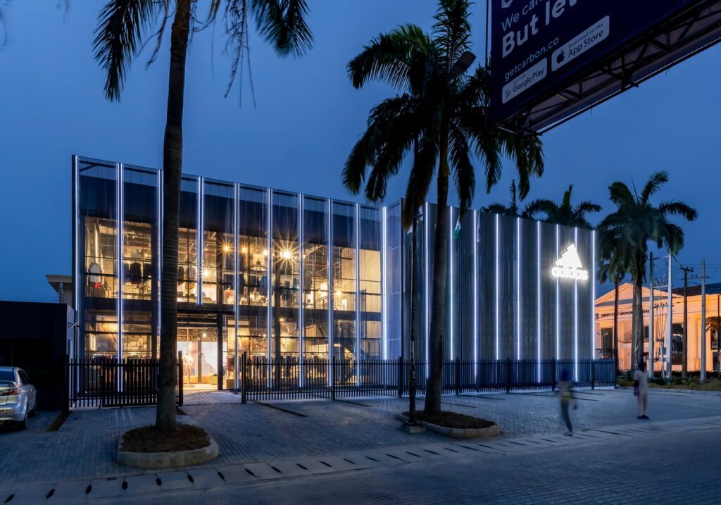 Night view of Adidas flagship store by Oshinowo Studios