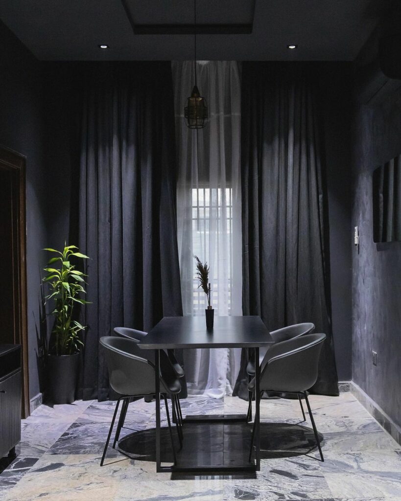 Dining area in Dark-Themed Contemporary Home By dhk Designs
