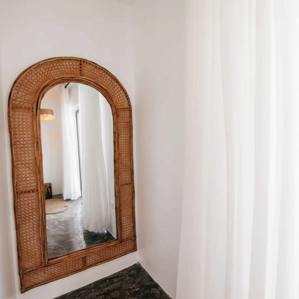 Rattan framed mirror in Mera Mera Lagos, a luxury Beach House Lagos