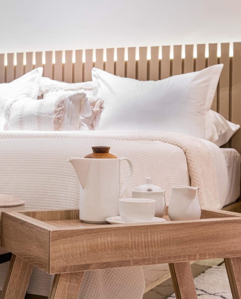 Showing headboard and wooden caddy in Scandi-style Bedroom By Interiors With Tega