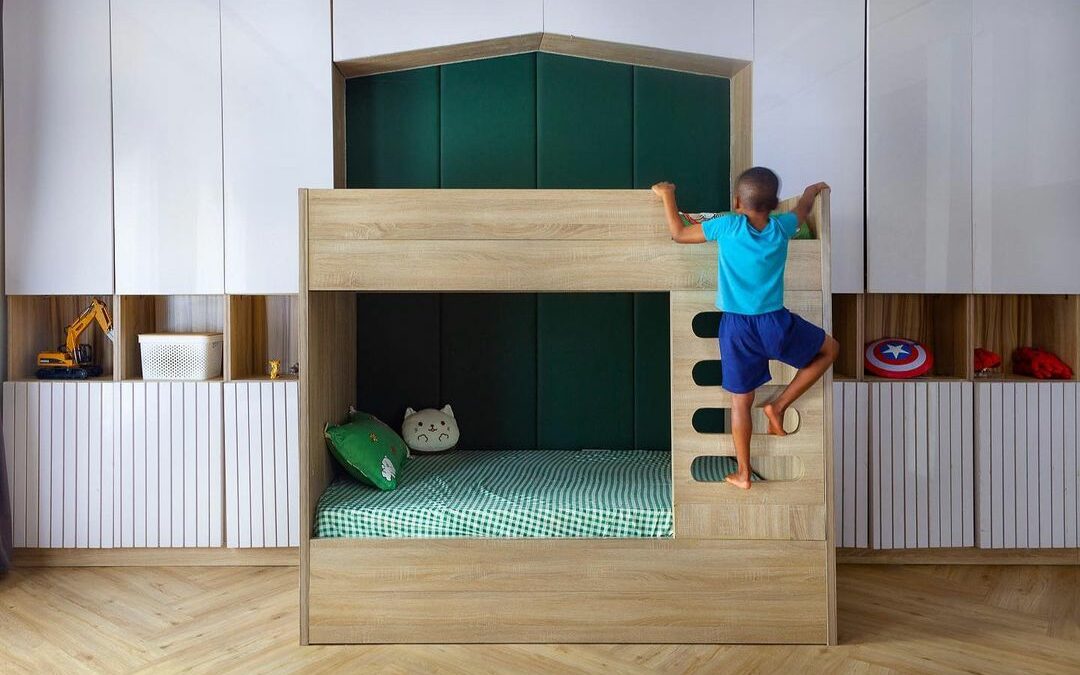 Children's bedroom in the modern family home in abuja showing a dynamic bunk bed flanked by ample storage.