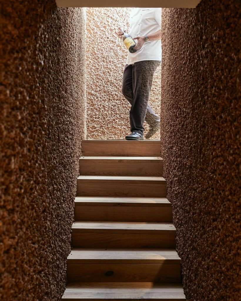 Stairs leading to Cork Wine Cellar in Cape Town By Wiid Designs with walls made of virgin cork.