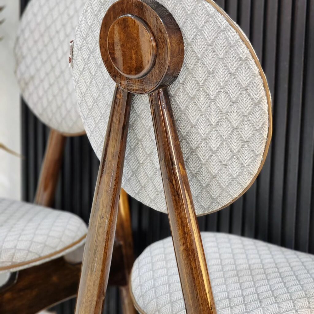 Back view of danish-style circular dining chairs by sobest furniture, a furniture production company in Benin City.