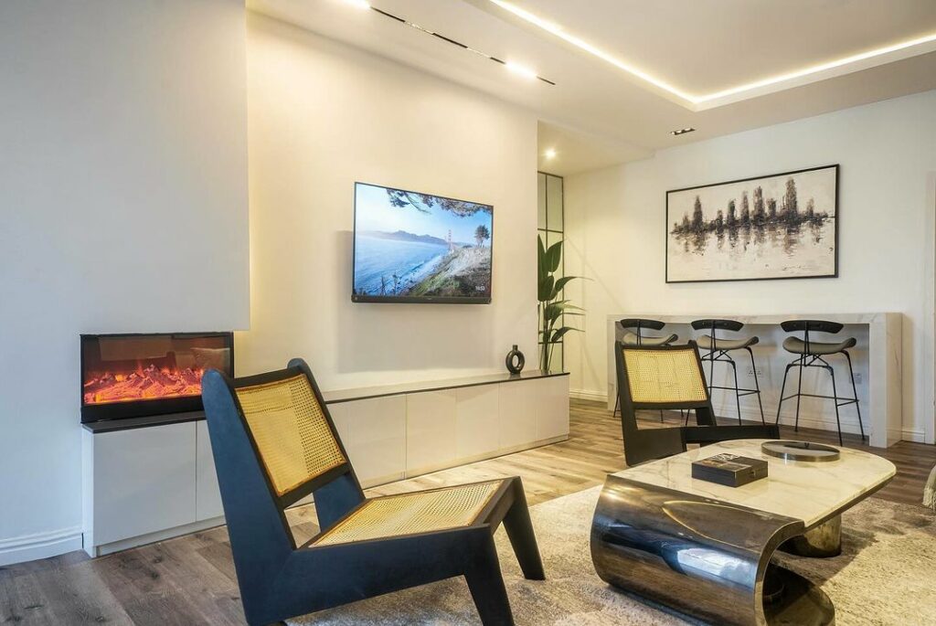 The TV wall / entertainment center and avant garde coffee table in the Modern Japandi Living Room In Nigeria By Wood And Nails Africa.