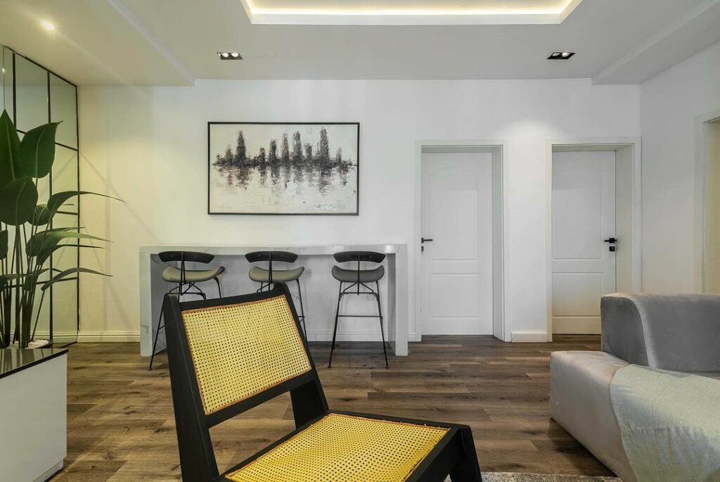 Accent chair, high seats and a nook in the Modern Japandi Living Room In Nigeria By Wood And Nails Africa