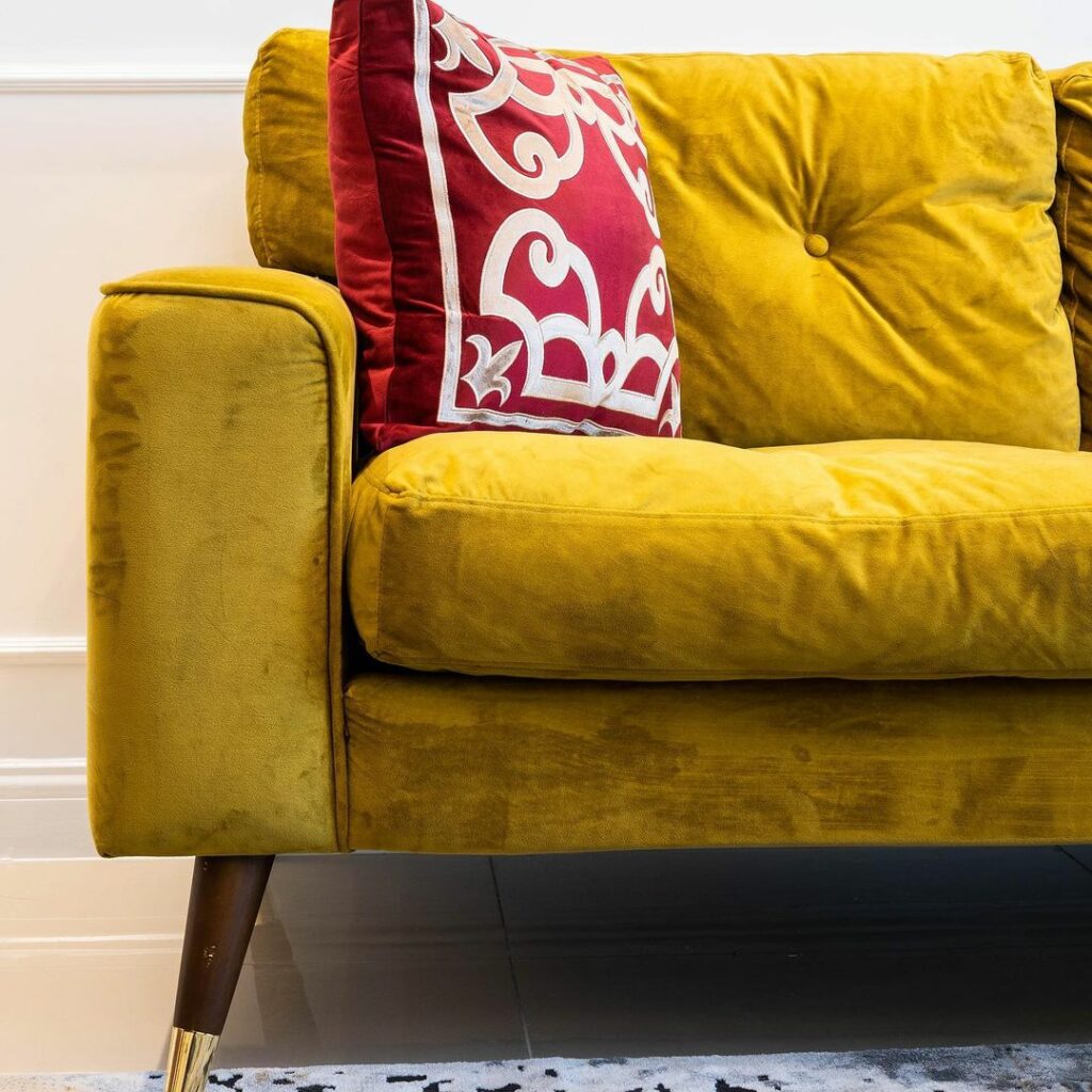 Mustard yellow sofa in Living room design by Onnalush Interiors