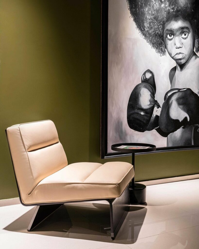 Low snug conversation seats in luxe olive green living room in Nigeria.