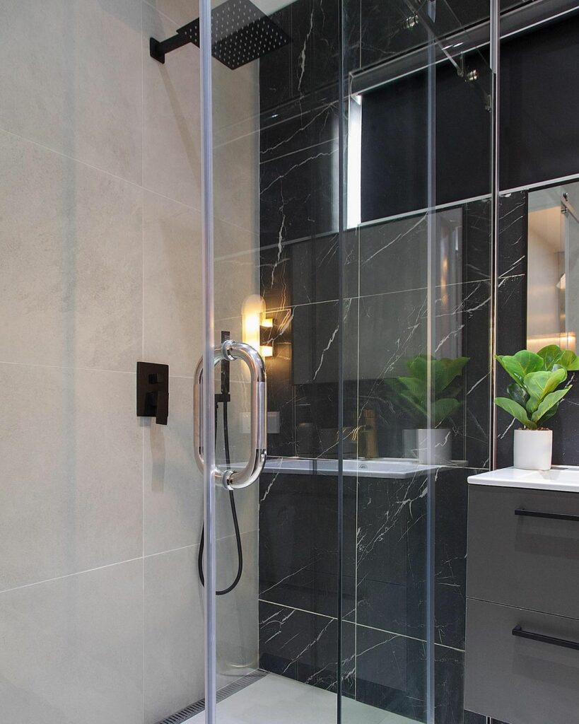 Shower stall in dark-themed master bathroom In Project Blue by OliveHaus Interiors