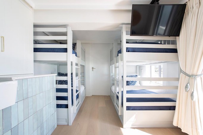 Two bunkbeds with blue themed bedding