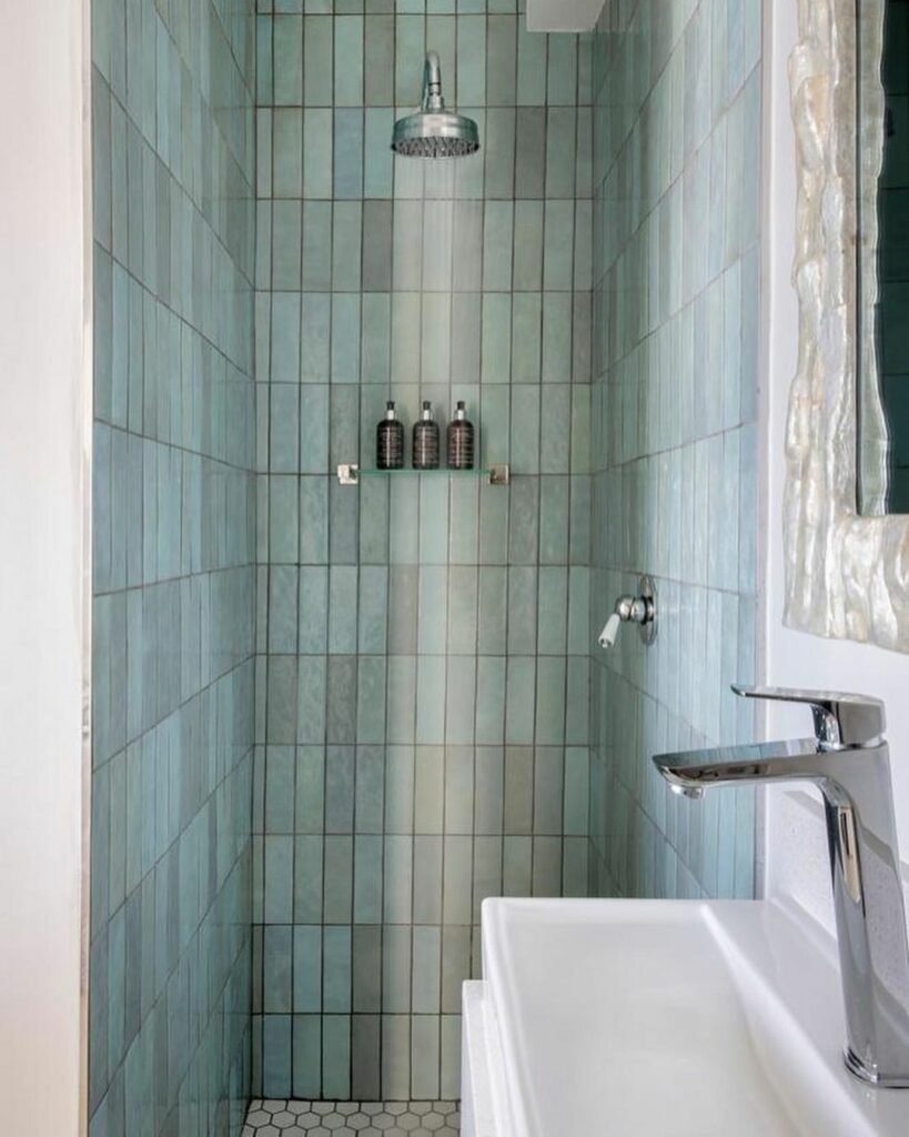 Shower stall with blue weathered wall tiles