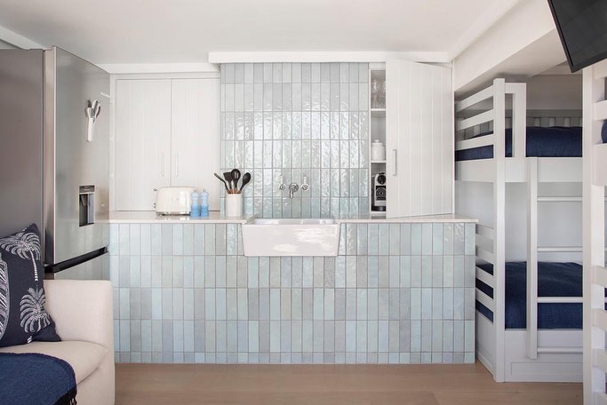 Open kitchenette with blue-weathered wall tiles