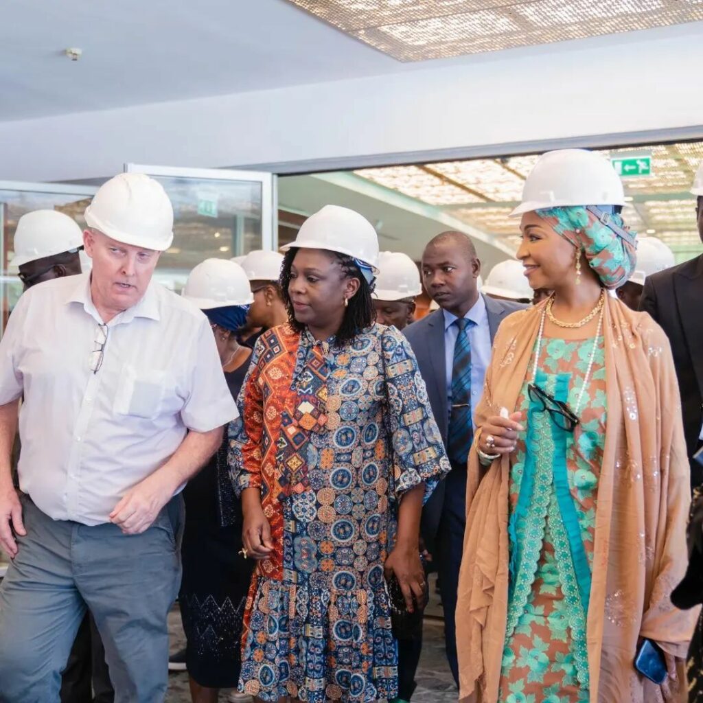 Tola Akerele and two others in a white hard hats.