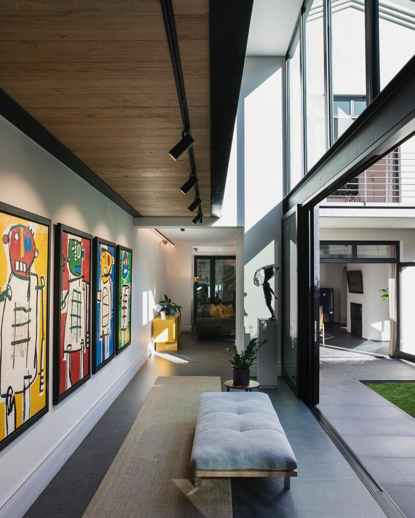 Entrance hall with art gallery wall and grey bench