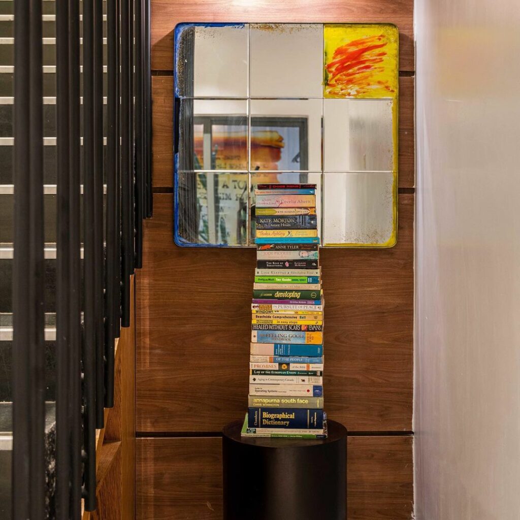 books stacked up as decor by staircase