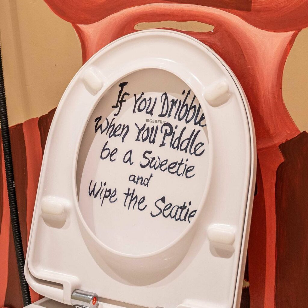 Writing on toilet seat saying: If you dribble when you piddle be a sweetie and wipe the seatie