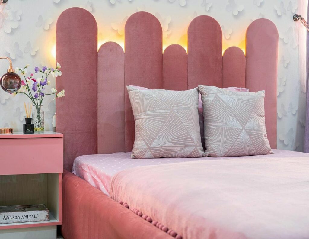 Pink sleeping area in a girls bedroom with a pastel colour scheme