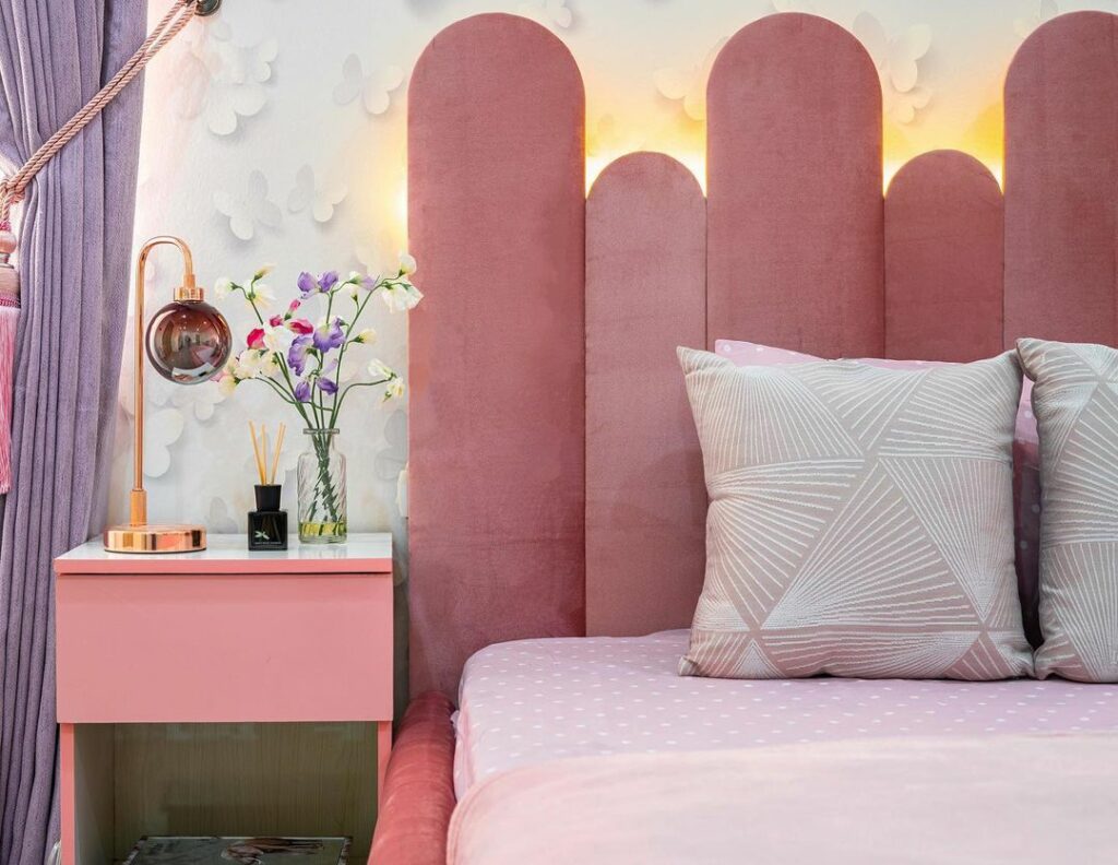 Girl's bedroom in Nigeria with pink headboard