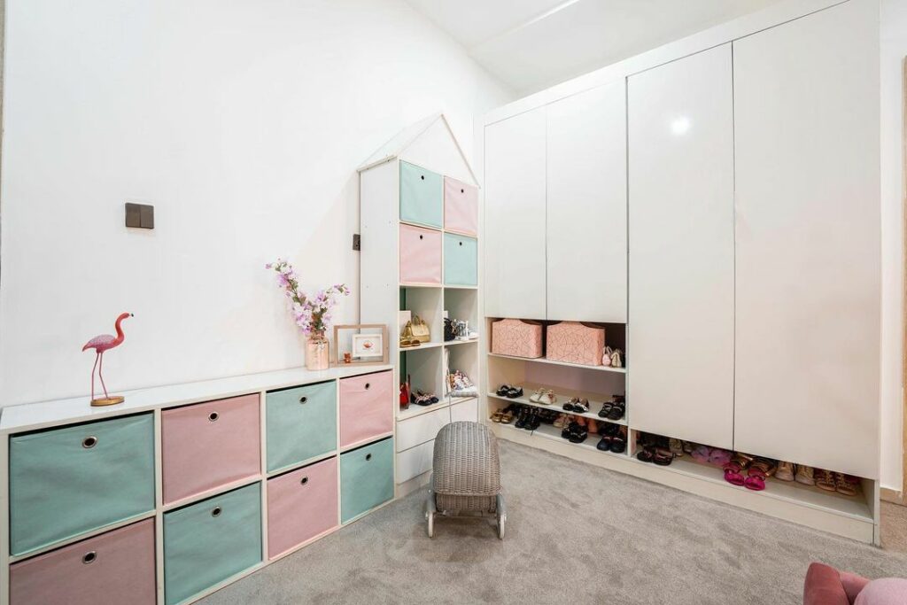 Castle-like storage joinery with colourful storage boxes