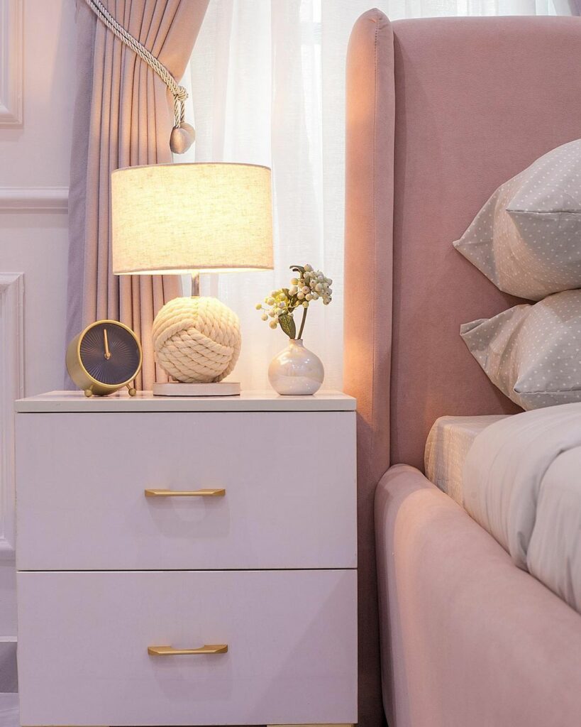 Pink-themed girl's bedroom by Olivehaus Interiors - a closer look at the yarn table lamp and gold table clock.