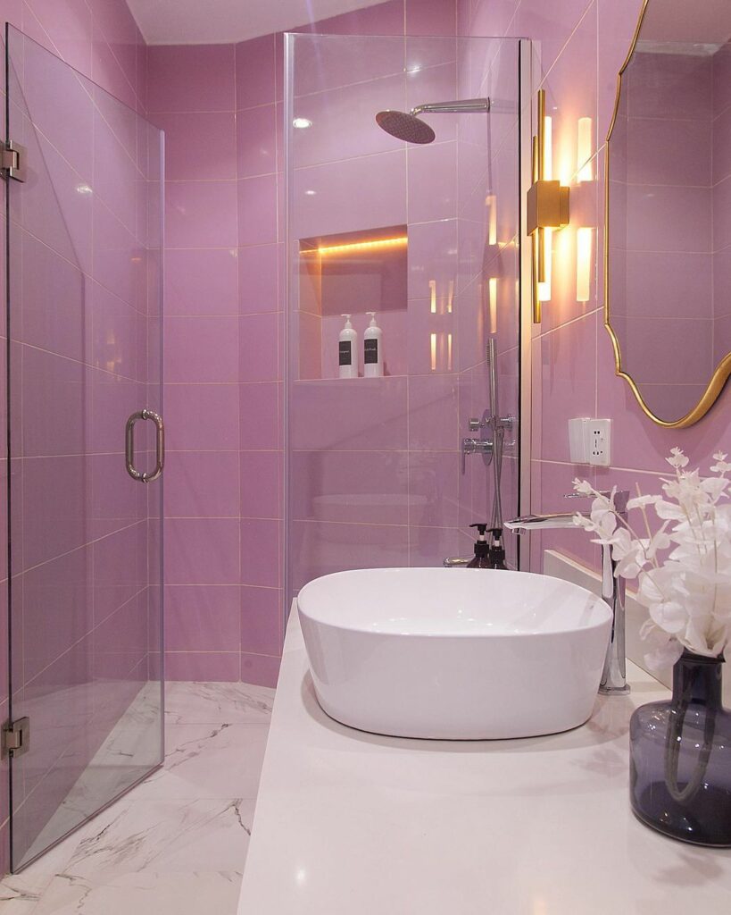 Pink-themed girl's bathroom by Olivehaus Interiors with a view of the shower area.
