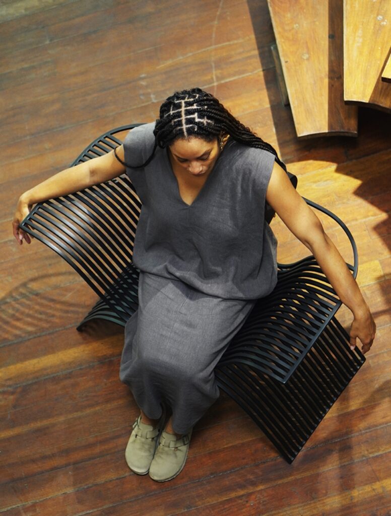 Lady sitting on The Patewo Chair by Salu Iwadi Studio.