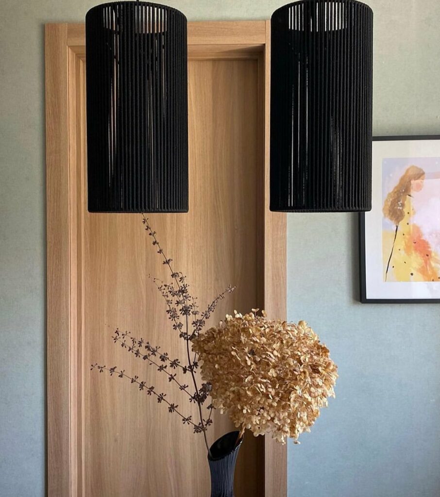 Black cylindrical Afrocentric Pendant Lights By Wodu Craft.