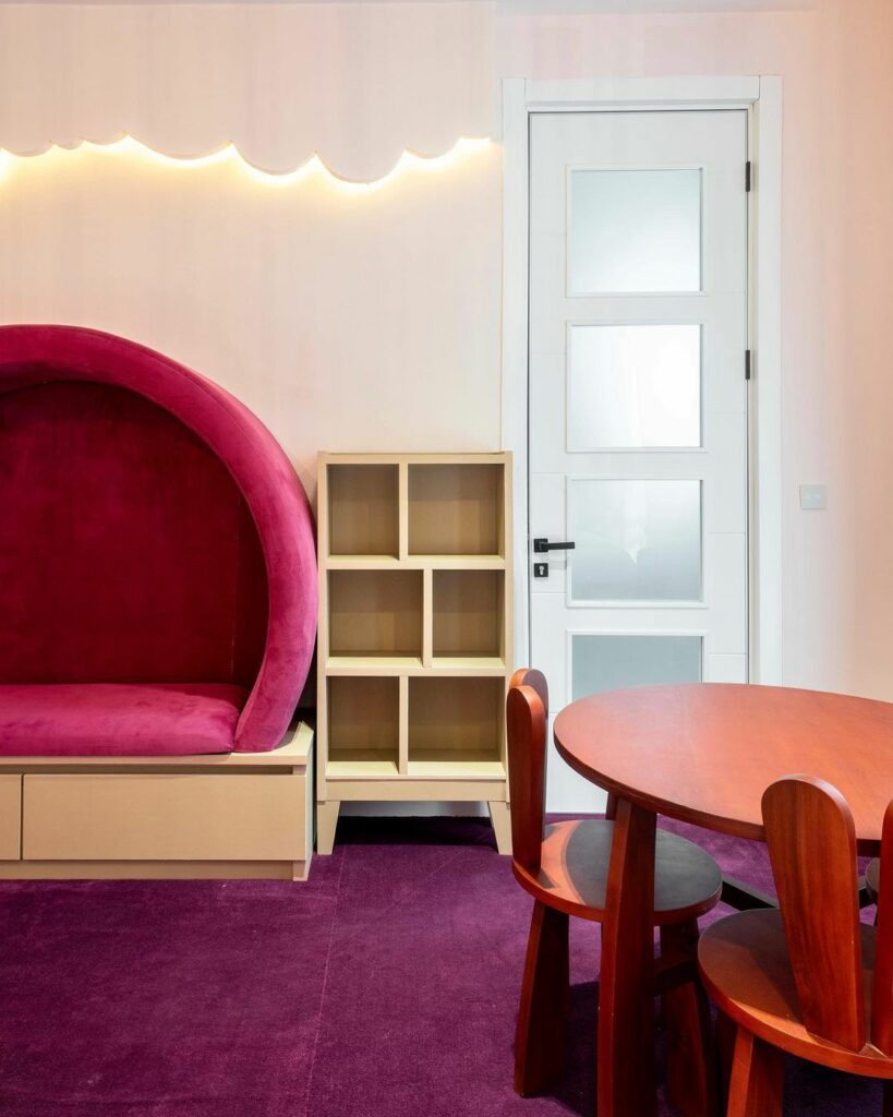 Booth seating in girls' bedroom with white classical door