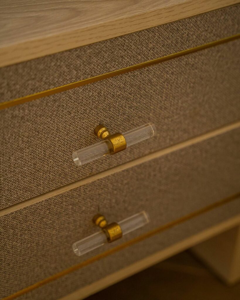 Close up shot of luxury nightstand with gold hardware.
