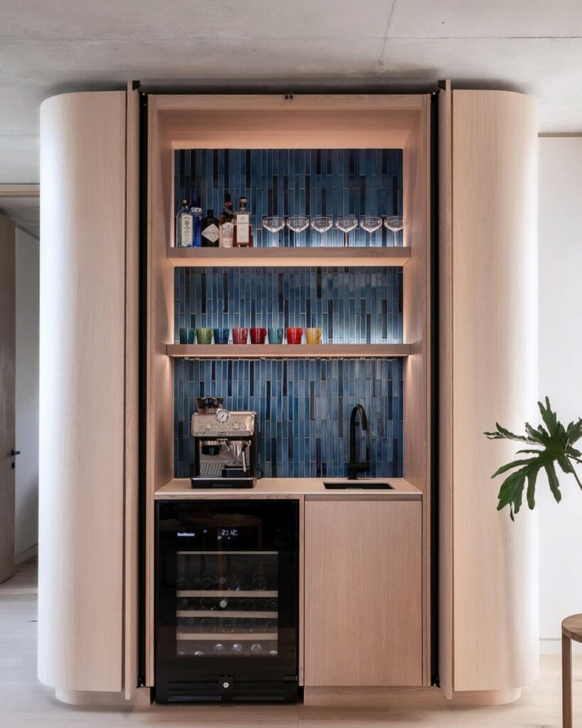 Concealed, modern coffee Station with coffee machine, sink and wine chiller.