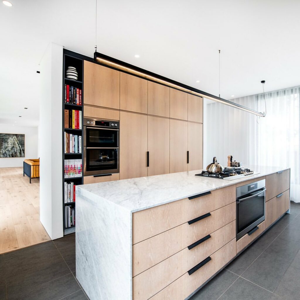 Modern kitchen in house S with a carrara marble top island.