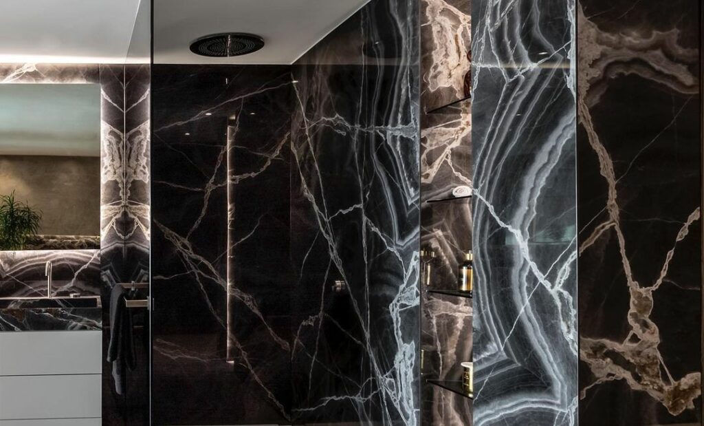 A view of the bathroom with luxurious dark marble walls.