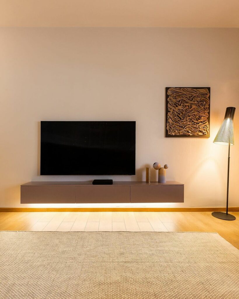 Minimal floating tv console and statement lamp.