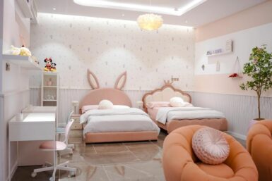GIrls' bedroom in Lagos by Greyson Living. View showing feather pendant light and bubble sofas.