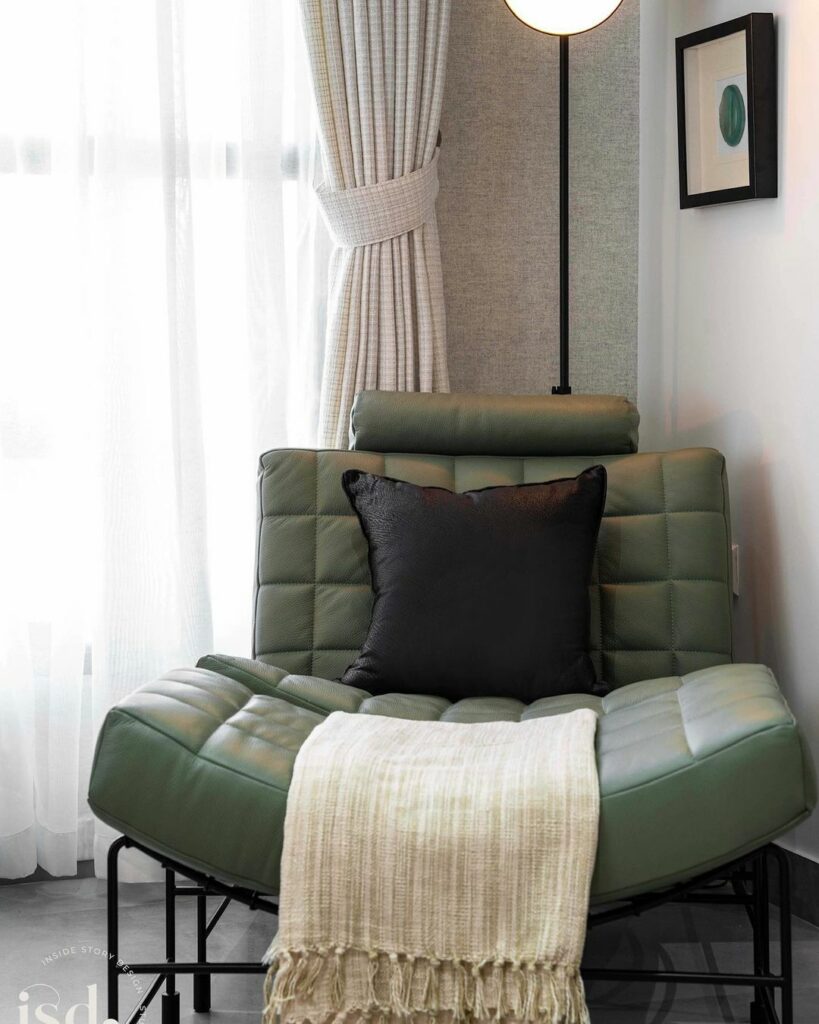 Modern green lounge chair and throw in reading corner.