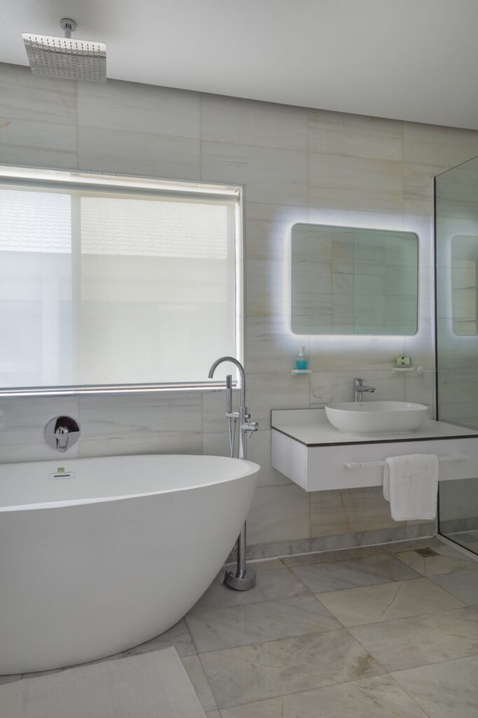 Modern white bathroom with sizeable window.