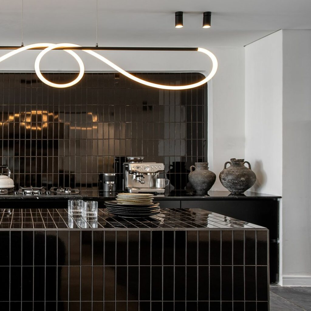 Dark-themed open kitchen in a residential project.