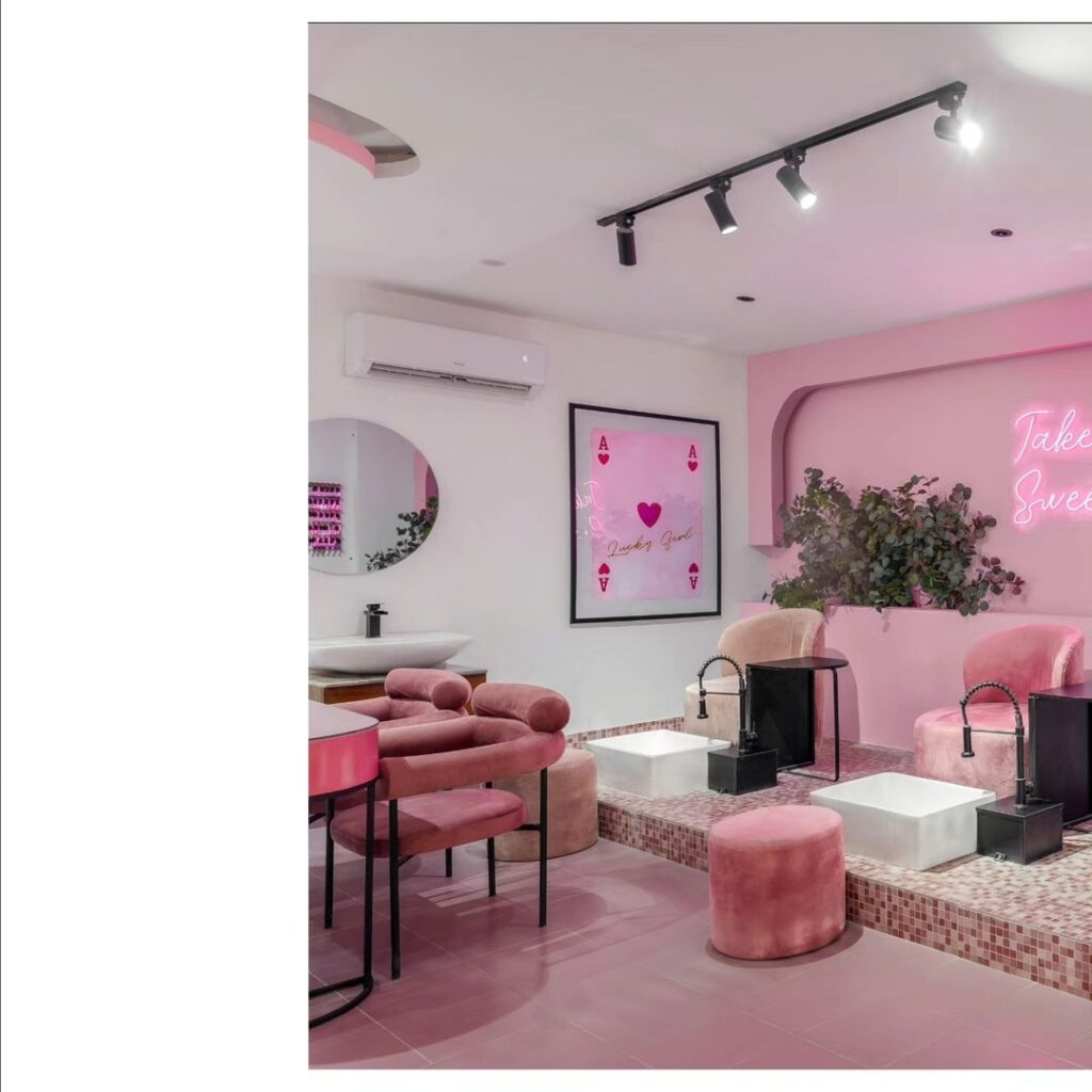 1. Pink salon interior with sign "looking good" in cursive font, featuring cozy atmosphere and elegant decor.