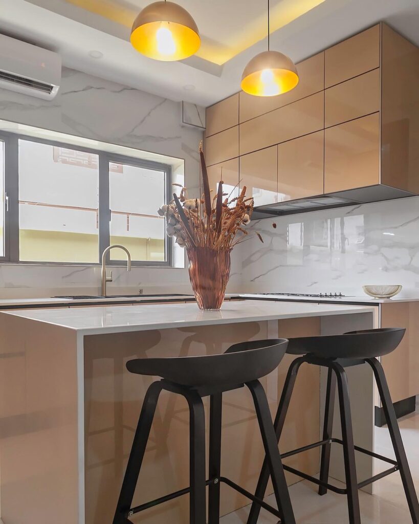 A contemporary kitchen featuring a white countertop and two stools.