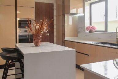 Kitchen with large island, sink, and seamless cabinetry.