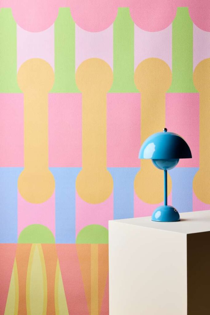 A vibrant wall adorned with a blue lamp perched on its surface.
