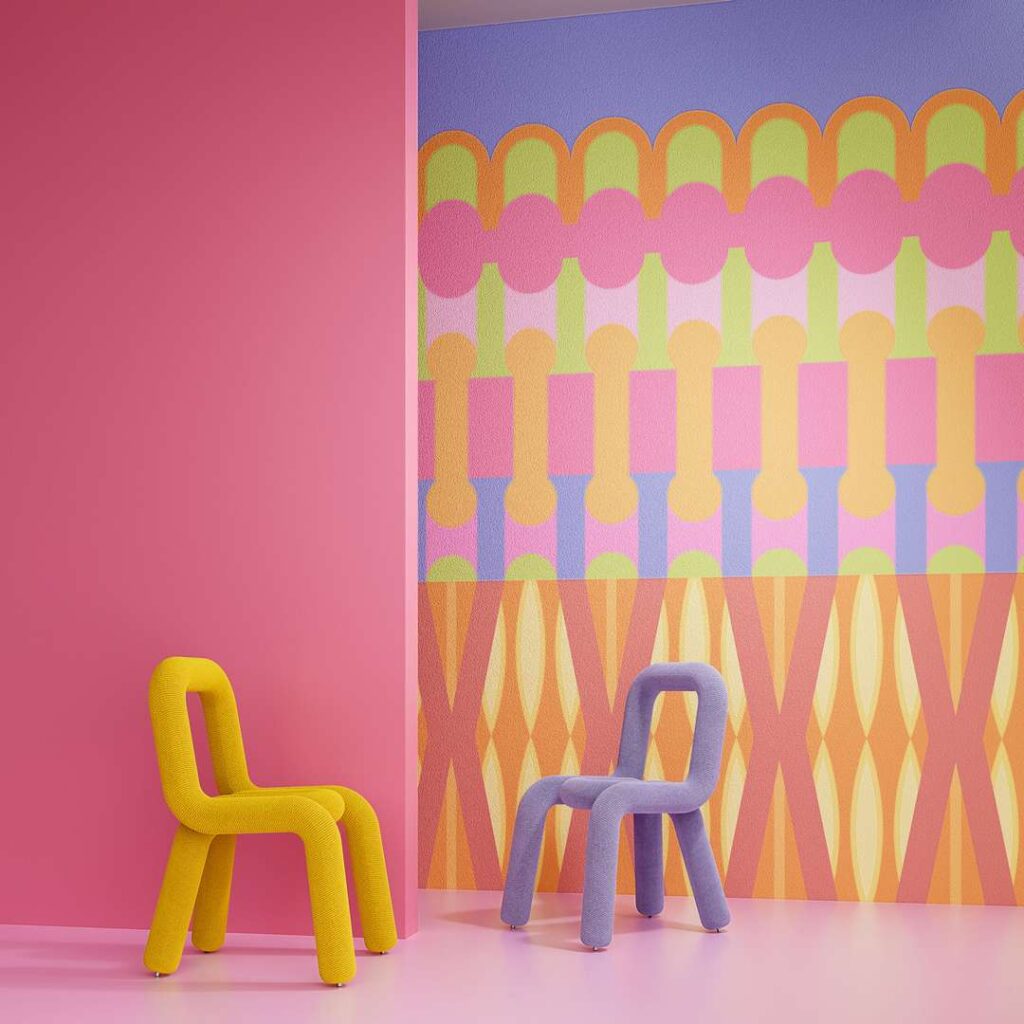 Two chairs placed in front of a vibrant, colorful wall.